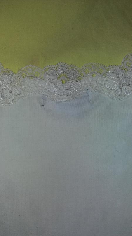 It said "All Cotton" and the tag inside was nowhere to be found on the Item description before purchase. That one says "Exclusive of Decoration" (lace trim) which was imbued with aftershave smell so strong that I had to wash it 5 x before trying it on.