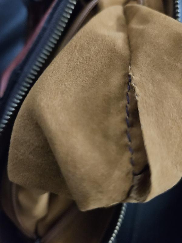 Inner pocket where stitching machine ran off the material