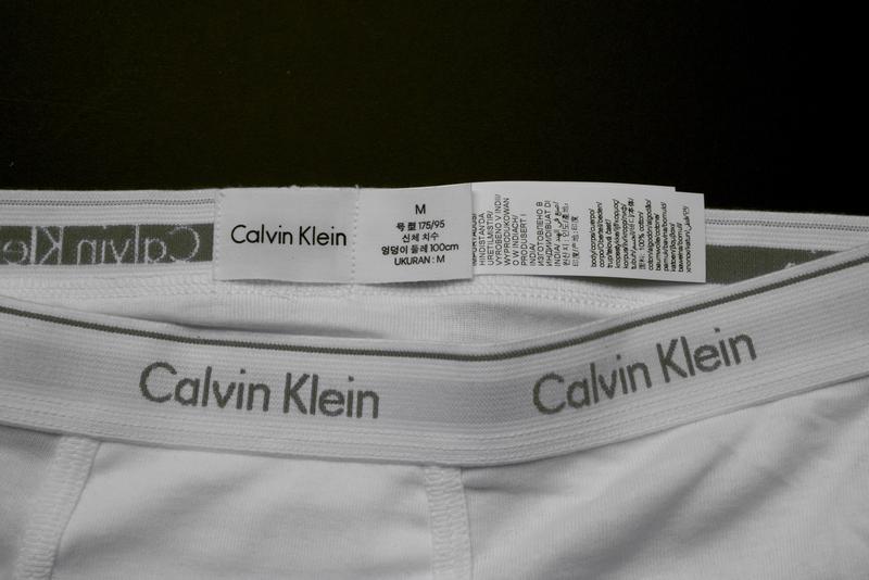 The long extra labels need to be cut away. The label with the size on it is supposed to remain. It should also be eliminated.