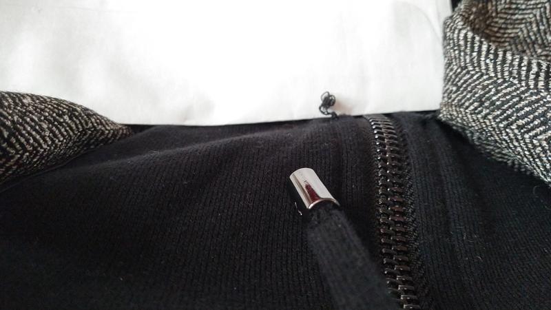 Looking down at opened lapel stitch while wearing.