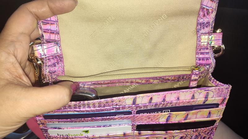 Holds phone, keys, my favorite purple lipstick and gloss duo, and my cards, eliminating the need for a wallet.