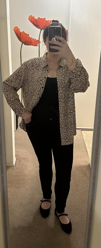 Shirt worn open with black tank and black denim leggings.