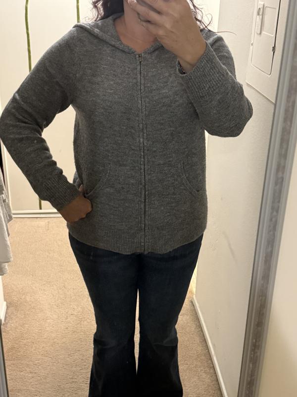 Hoodie worn zipped up.