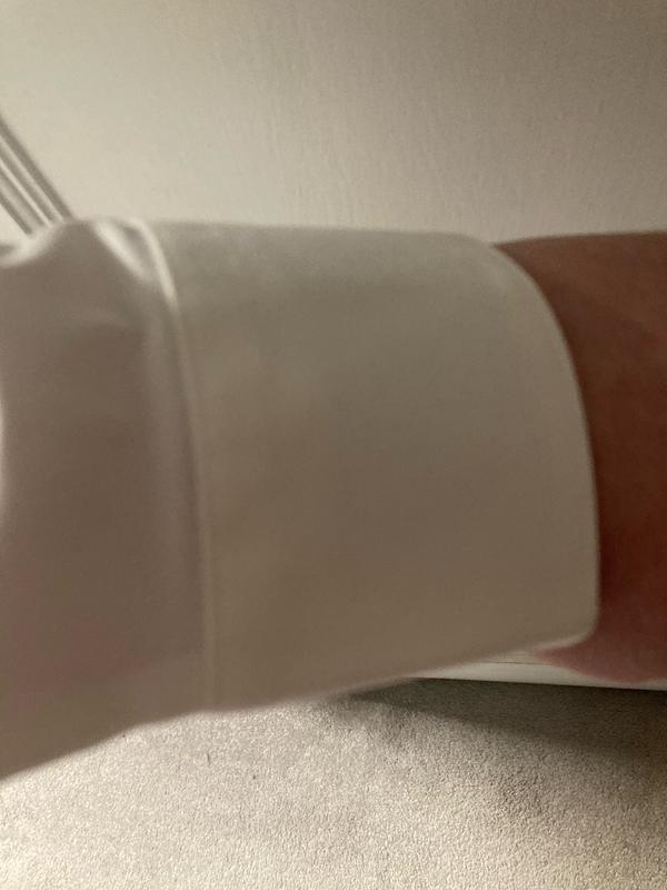 Stitching detail around cuffed sleeve