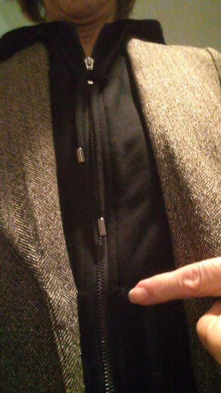 Pointing to opened lapel stitch.