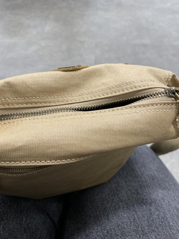 Zipper is full closed, but part of the zippered area has popped open. This happens about half the time I zip it. Sometimes it opens completely