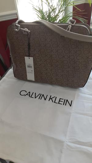 Tote also comes with a logo protective bag to store it