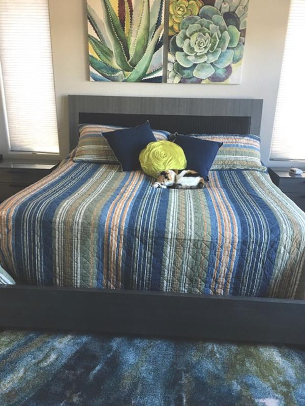 Beautiful focal piece and ties the bed colors to the pictures above it.