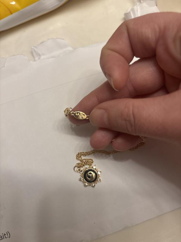 Second photo is the glued in gem