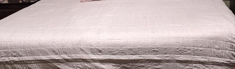 On a king sized mattress with overhead lighting - note texture and very light Gray color