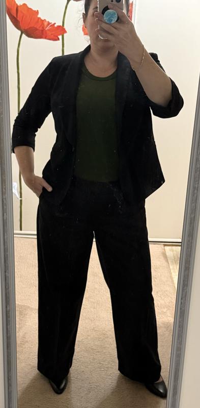 Bodysuit with black wide leg pants and short blazer.