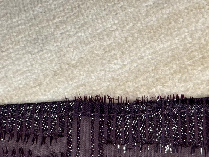 Little threads not bound in hem- sticking out below hem