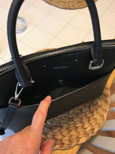 large front magnetic pocket, holds my large Iphone with case, plus other items