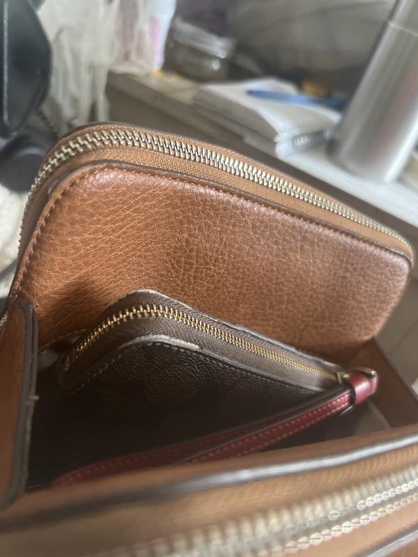 Wide open pocket with wallet coming out.