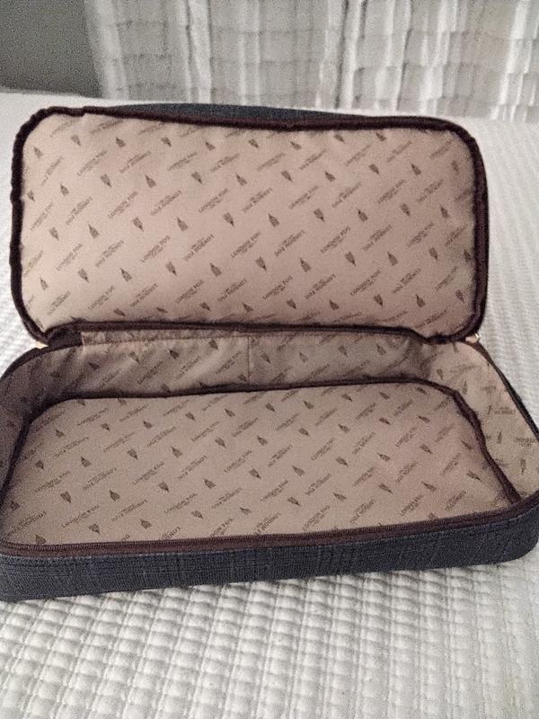 Bag held my toiletries, makeup and 2 pr of sandals.  Had room for a few more sandals.  Picture of bottom zippered compartment