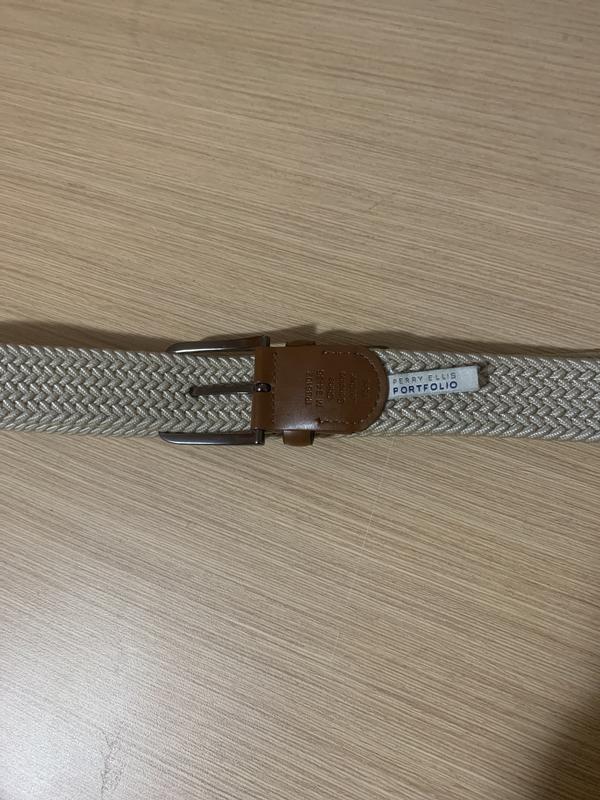 The belt will come with a rubberized plastic sheet where the tag was attached, but you can easily cut that out