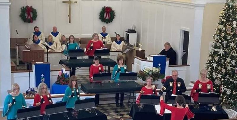 handbell choir wearing tops. Several tops have the sleeve bells attaches wrong.