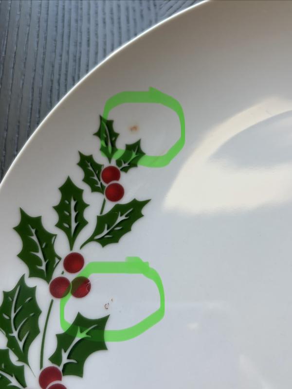 Random red paint spots.  Also leaf patterns were unfinished on pieces