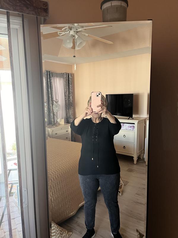 Sweater with cross tied strings closed.