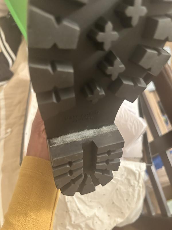 That is mold around the bottom and side, not sticker residue. The boot even has a mild smell.