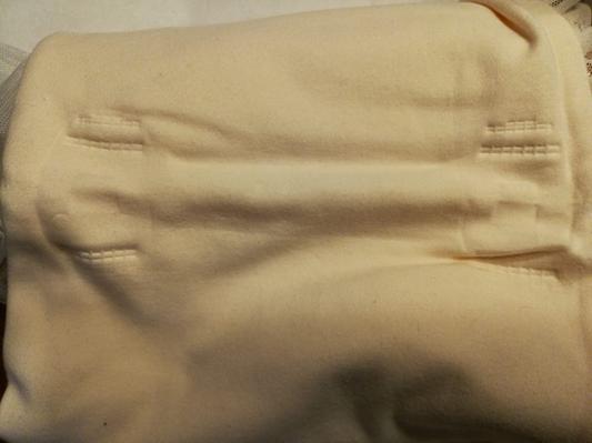 Blanket was attached to hanger inside a bag