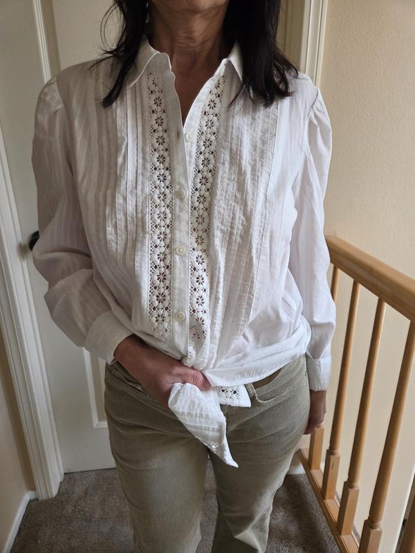 Over, in or knot with the pants.