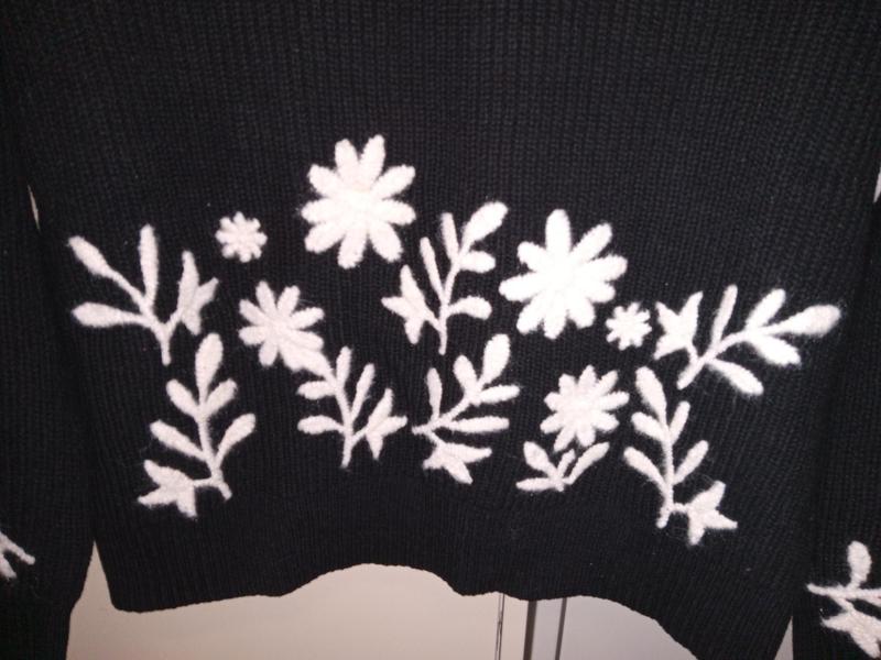 Close-up of embroidery om front of sweater.