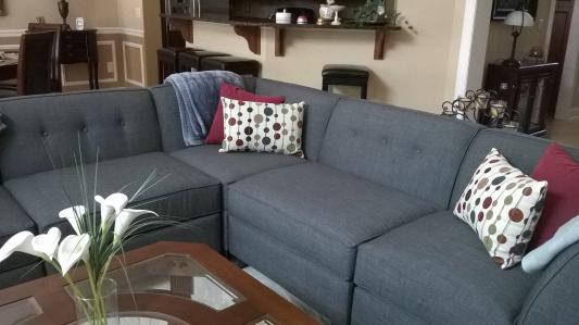 Colorful polka dot pillows look great with the slate blue