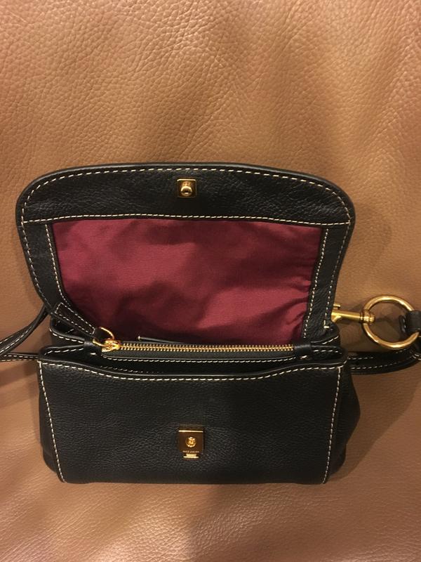 Multiple internal compartments including a zippered pouch make it easy to stay organized! The snap on the top flap can be a bit tricky to close.