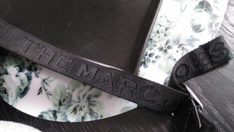 Strap on backpack showing the etched letter.