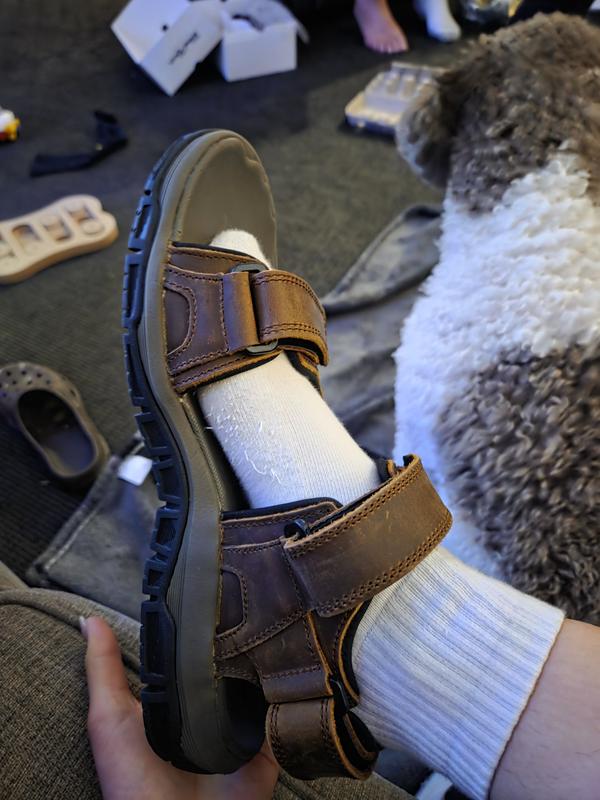 Size 7 womans foot wearing the size 11 mens sandal