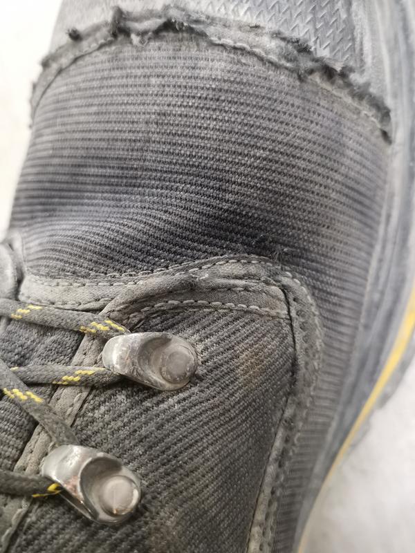 Left boot: Toe cap seam is fraying and there is wear around some of the lacing lugs

This is after two weeks of 10s. Sheet metal worker, inside building, concrete floors

This is due to poor quality, not damage from sharp edges or snags