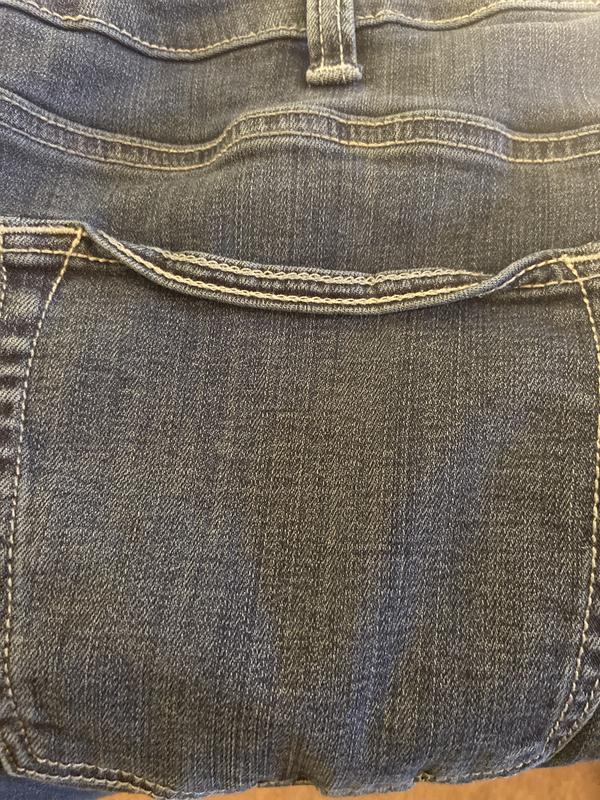 Top part of both back pockets folded over after washing
