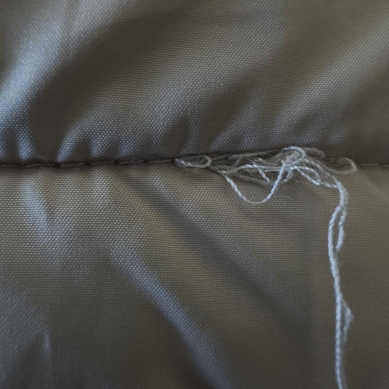 Stitching above the cuff of the coat.