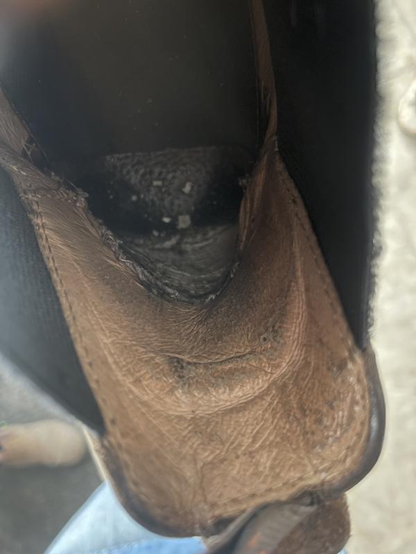Inside on both heels wearing and disintegrating. The white bits are part of the inner layer of the boot.