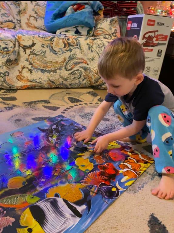 Doing the floor puzzle on Christmas day( xmas tree lights glare)
