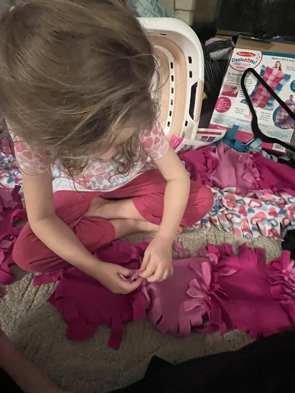 5 year old helping to thread ties