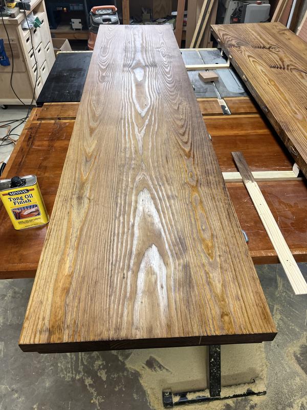 One half of the breakfast table top I'm refinishing. Second coat of Minwax Tung Oil Finish drying. It's looking good already! Sorry for harsh workshop lighting.