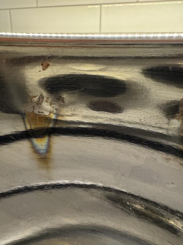 Rust on inside of bucket behind where the handle is soldered