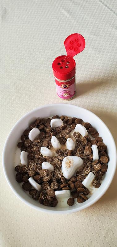 Shaker, flip-top lid. See the dusting of topping applied