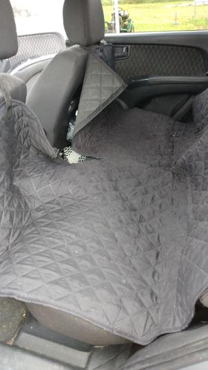 Unzipped so he can easily get in the backseat from the front seat