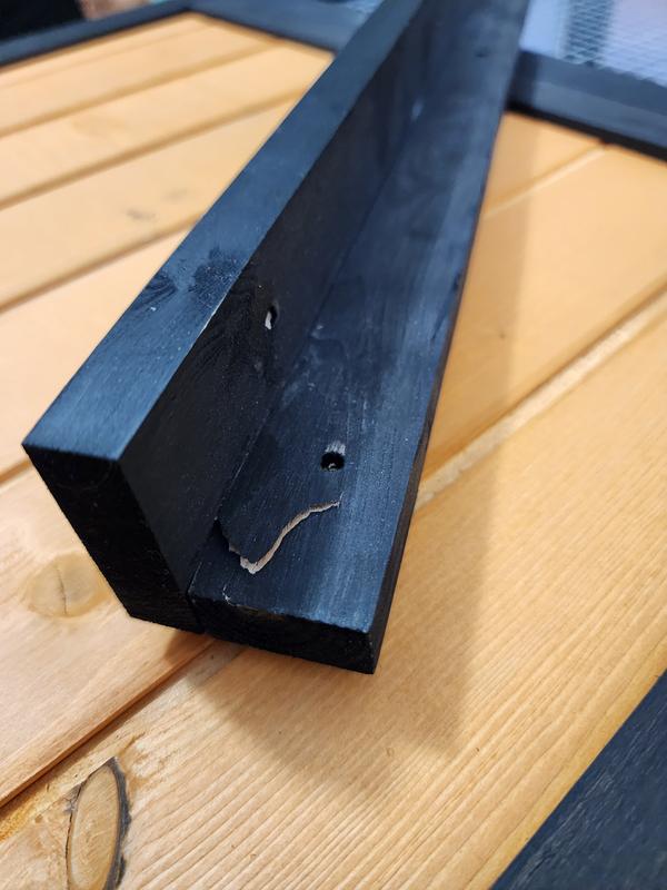 The wood has some splits caused by the screw holes being drilled.