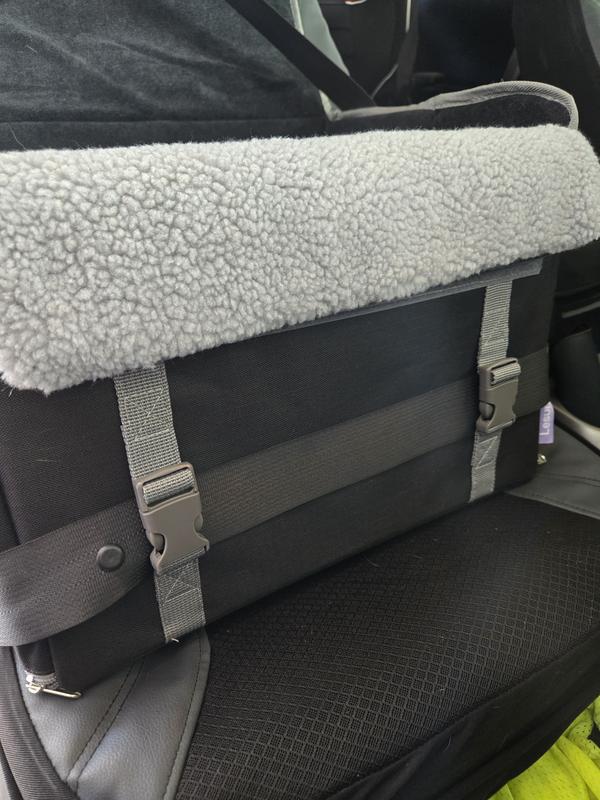 Seatbelt secured and held in olace with front clips.  Also the padded gaurd over the front.