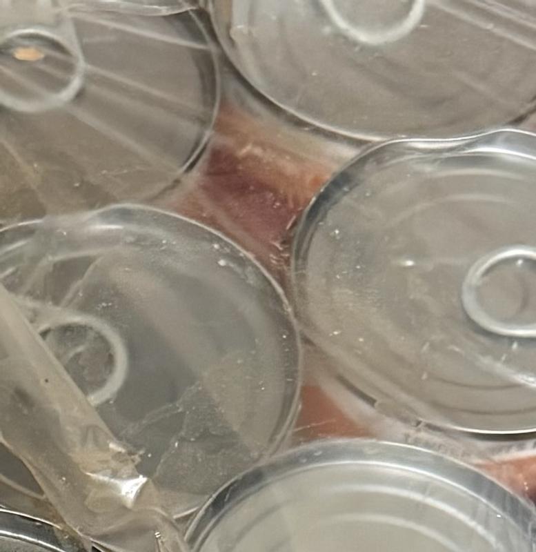 Wet under plastic, other cans wet