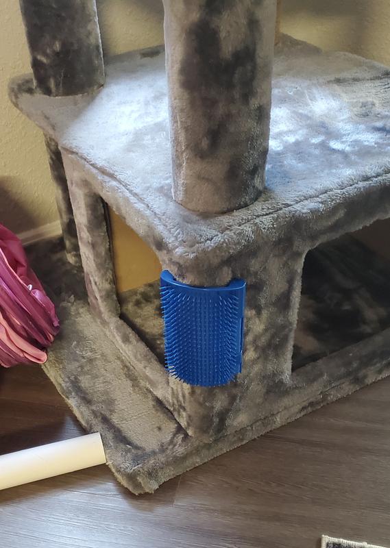 Brush mounted to a corner of a cube on my cat tree
