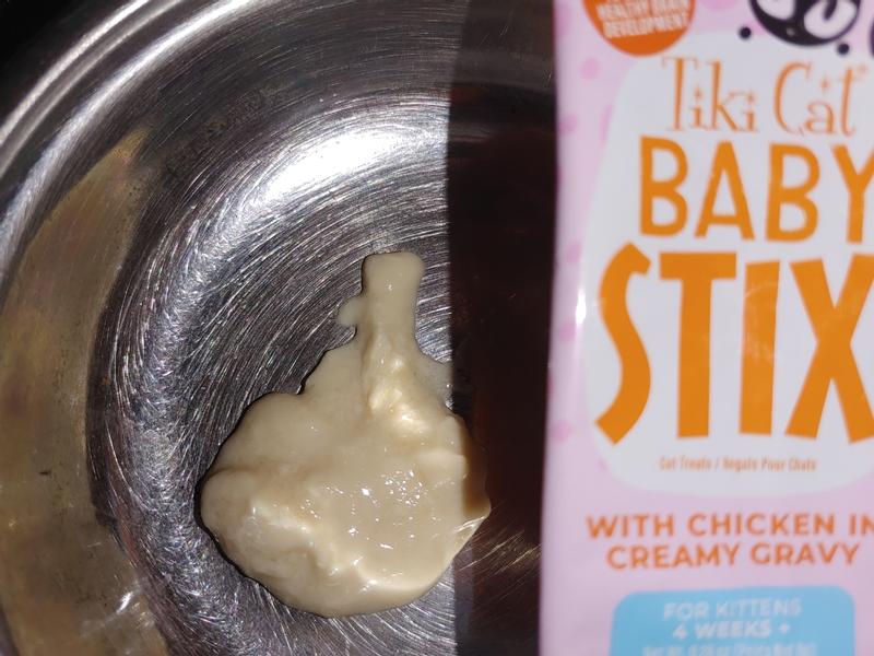 Tiki Cat Baby Stix. They are chicken flavored in creamy chicken gravy. This photo is of me squeezing the treat out of the package.