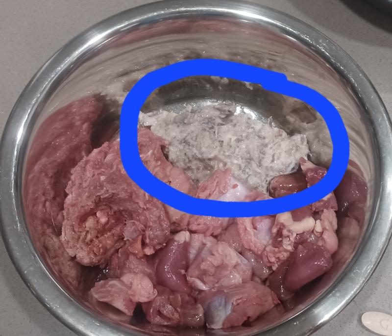 1/3rd thawed tripe patty with dogs' other raw food