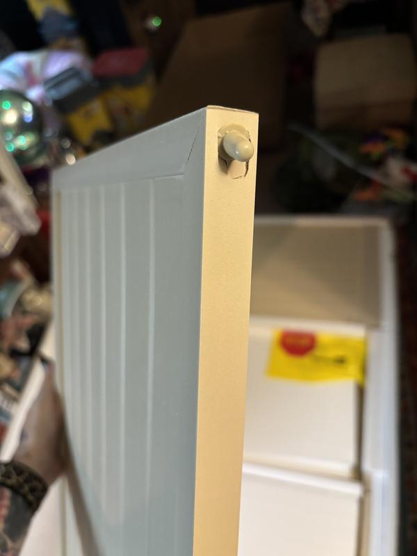 This is the broken nub on the door which will slide into the bottom piece of the stand