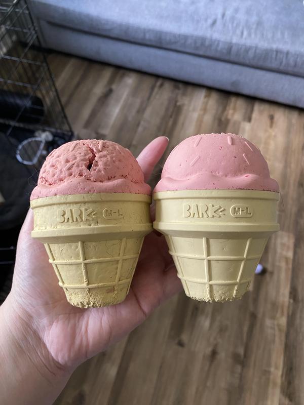 Two of the same icecream toys, the old one on the left, full of teeth marks and dents next to a newer one with just a few teeth marks on the top and bottom