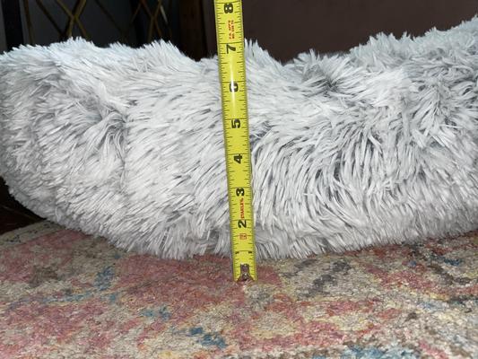 6 or 7 inches high bolster - most fluff is in the center